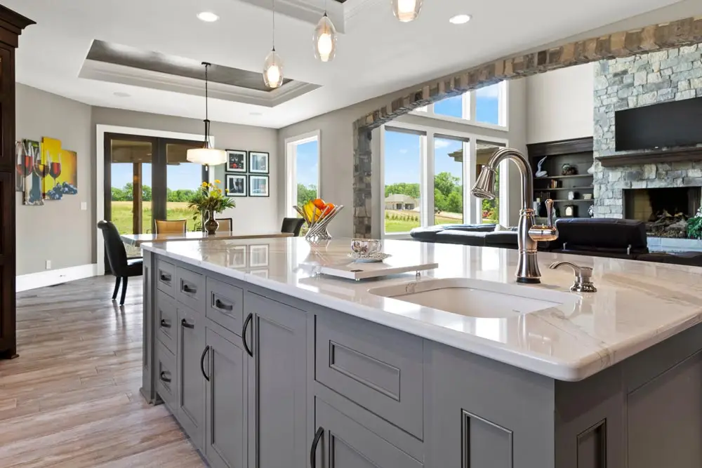 A Custom kitchen with a central island and a fireplace, creating a cozy and functional space for cooking and gathering.